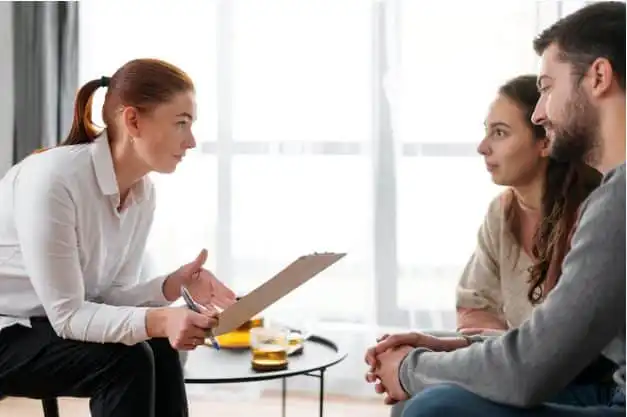 Therapist conducting a counseling session with a couple in Indonesia.